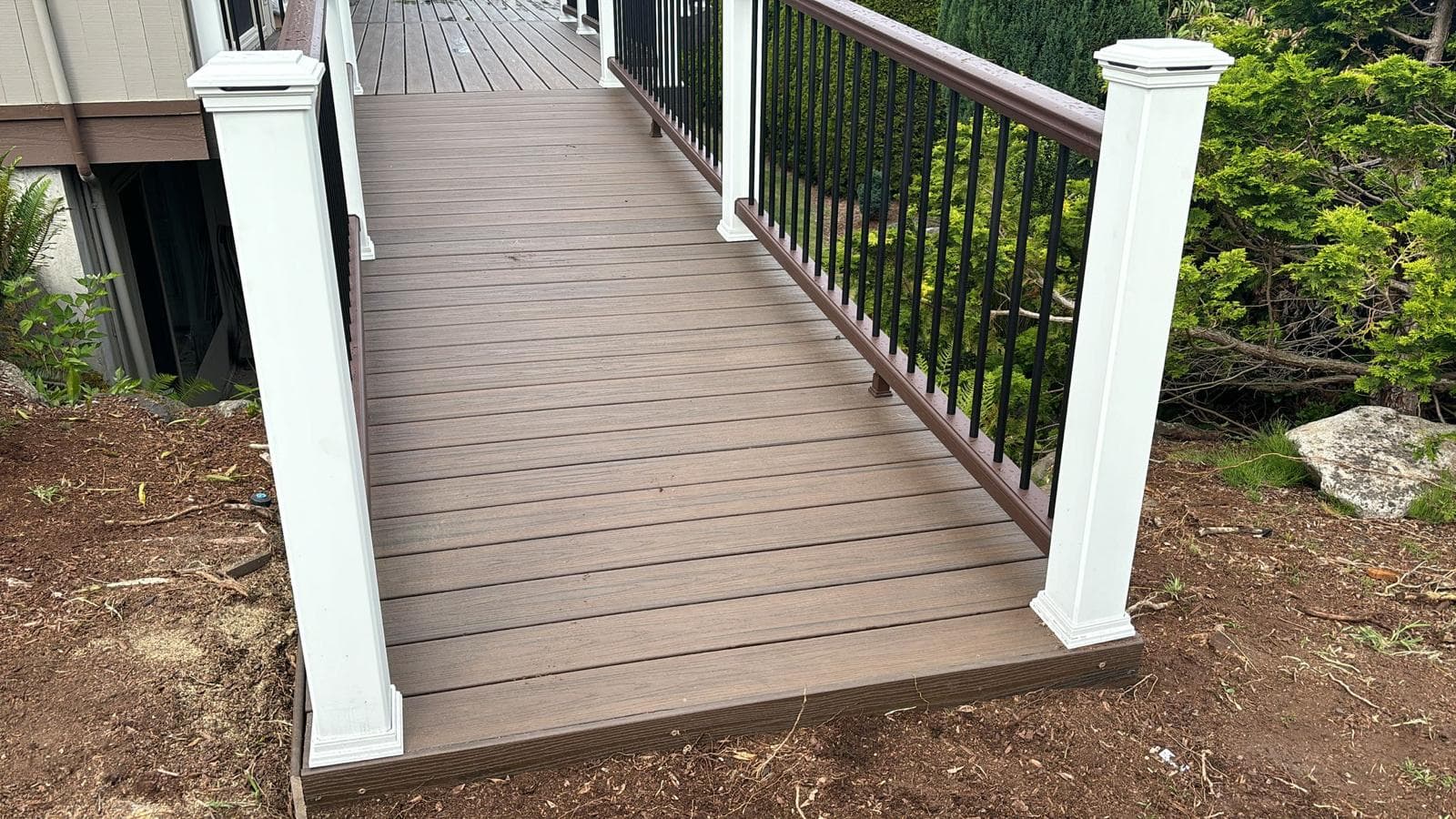 Decking — brown composite deck with iron rail