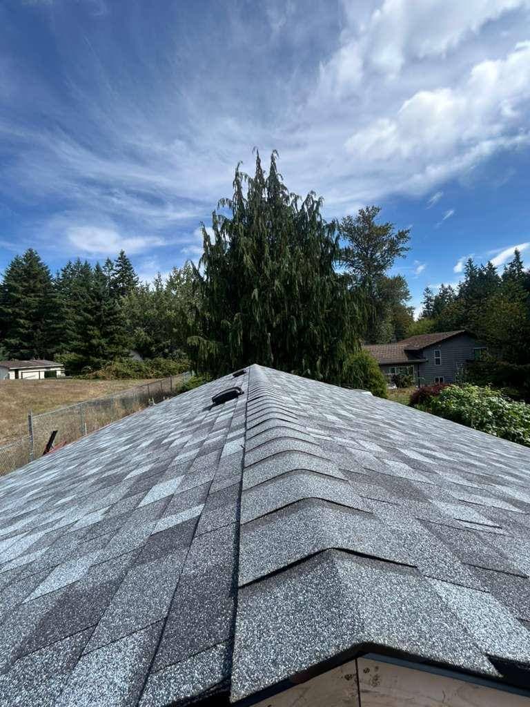 Completed architectural shingle roof with ridge cap and ridge vent